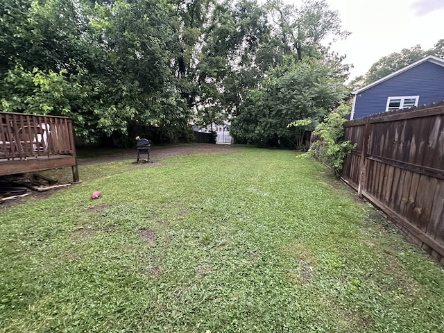 view of yard with a storage unit and a deck