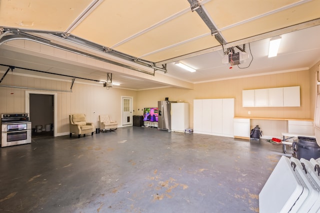 garage with a garage door opener and stainless steel refrigerator with ice dispenser