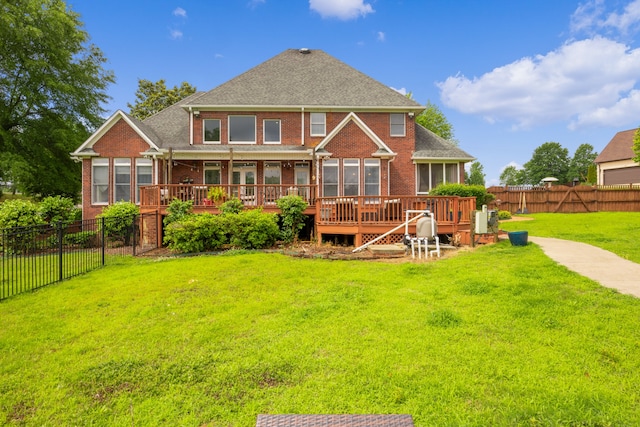 back of house featuring a yard and a wooden deck