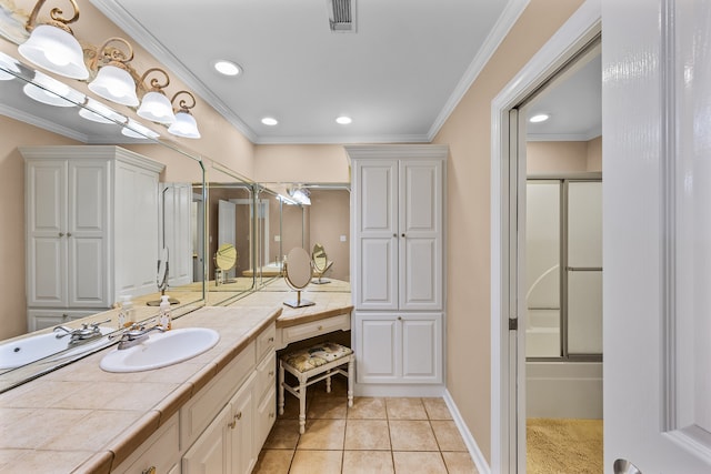 bathroom with tile flooring, oversized vanity, crown molding, and combined bath / shower with glass door