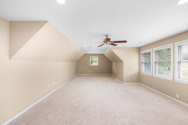 bonus room with light carpet, ceiling fan, and vaulted ceiling