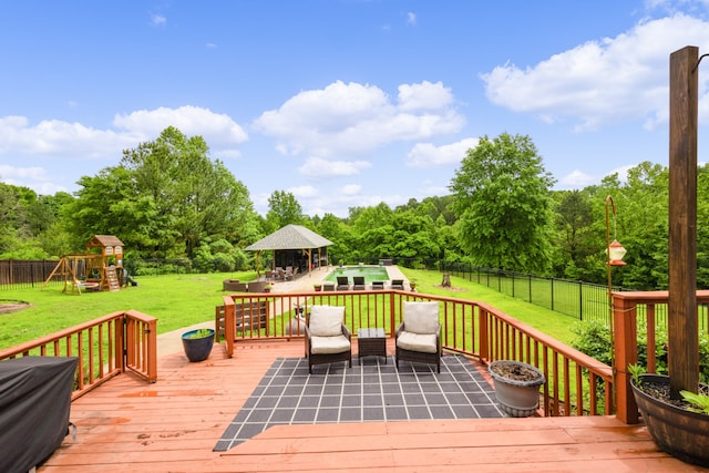 deck with a playground and a yard