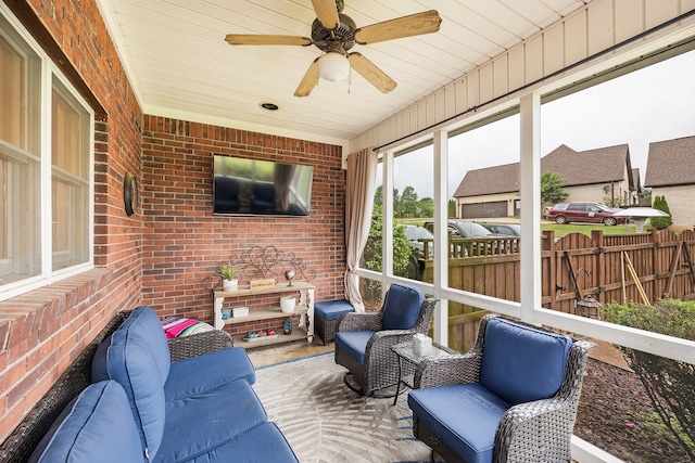 sunroom featuring ceiling fan