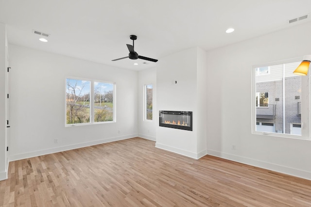 unfurnished living room with ceiling fan and light hardwood / wood-style floors