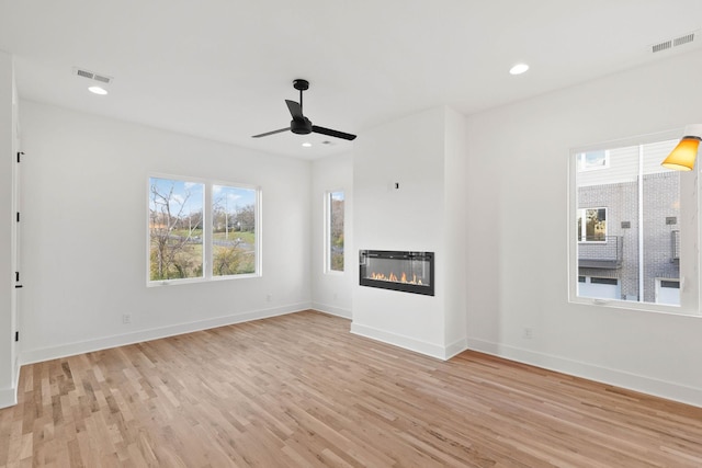 1016 W Trinity Ln Unit 2, Nashville, TN 37218 - unfurnished living room featuring light wood-type flooring, a ceiling fan, a glass covered fireplace, and recessed lighting
