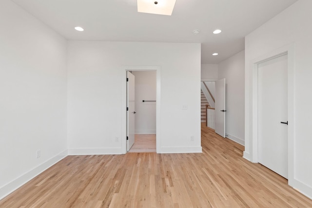 unfurnished room with light wood-type flooring