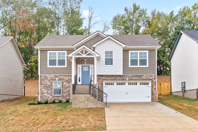 split foyer home featuring a garage and a front yard