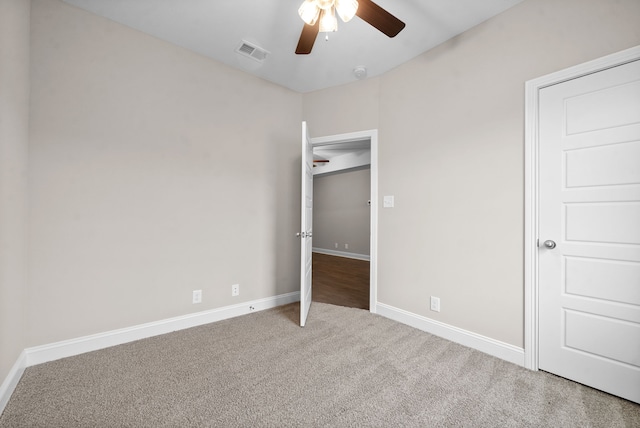 unfurnished bedroom with ceiling fan and carpet flooring