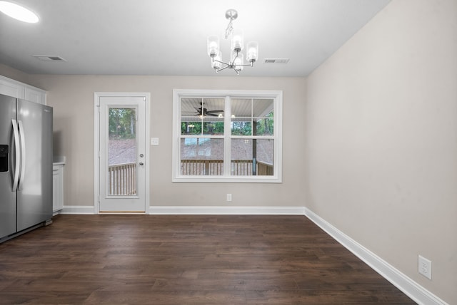 interior space with ceiling fan with notable chandelier, dark hardwood / wood-style flooring, and a healthy amount of sunlight