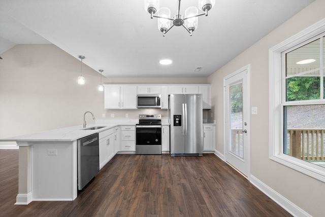 kitchen with kitchen peninsula, stainless steel appliances, white cabinets, and hanging light fixtures