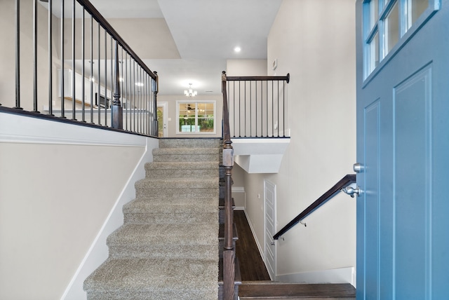 stairway with hardwood / wood-style flooring