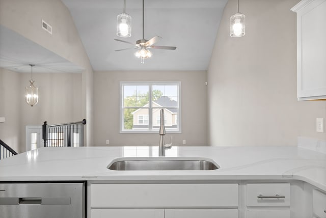 kitchen with dishwasher, light stone countertops, white cabinetry, sink, and lofted ceiling