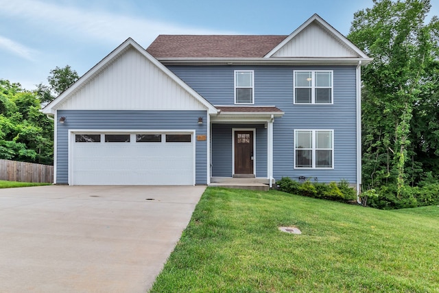 view of front of property featuring a garage and a front yard