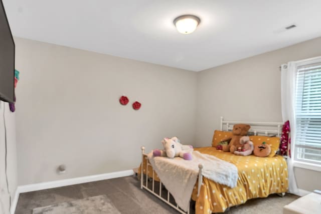 bedroom with dark colored carpet