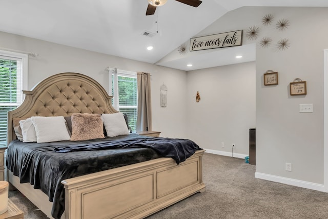 carpeted bedroom with ceiling fan, multiple windows, and lofted ceiling