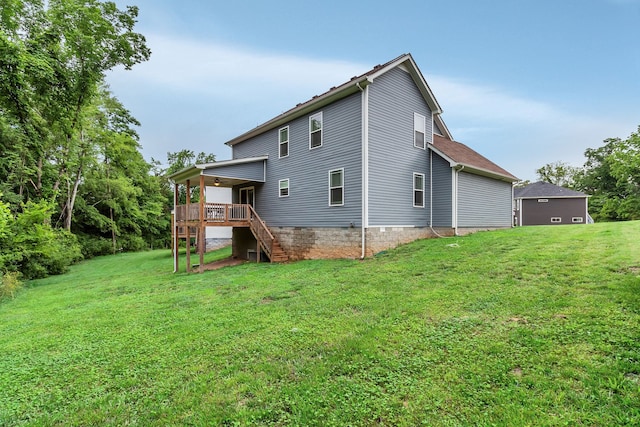 back of property featuring a wooden deck and a lawn