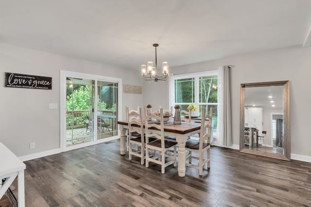 dining room with a wealth of natural light, dark hardwood / wood-style floors, and a notable chandelier