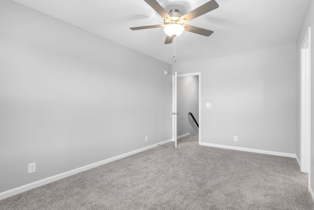 empty room with ceiling fan and carpet floors