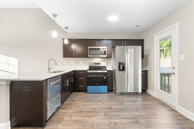 kitchen with light hardwood / wood-style floors, sink, stainless steel appliances, and dark brown cabinets