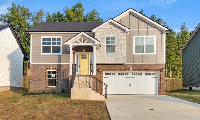 view of front of home with a garage and a front lawn