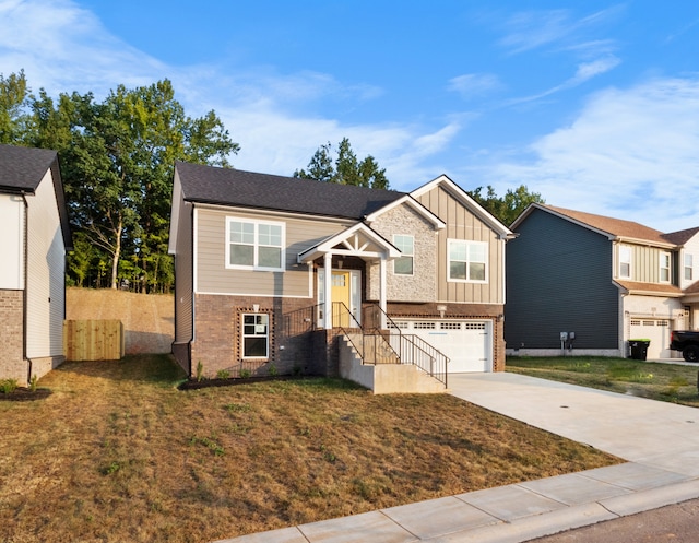 split foyer home with a garage and a front yard