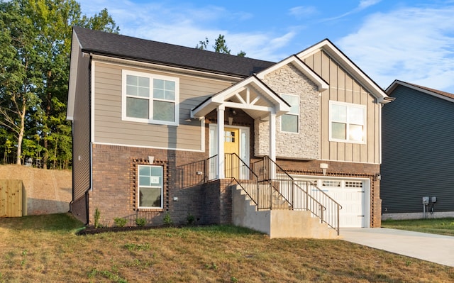 raised ranch with a garage and a front lawn