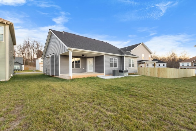 rear view of property featuring a yard and a patio