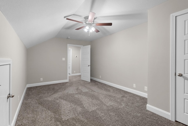 unfurnished bedroom featuring ceiling fan, carpet flooring, and lofted ceiling