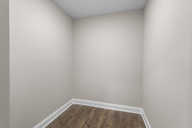 unfurnished room featuring dark wood-type flooring