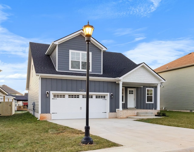 craftsman inspired home with a front yard and a garage