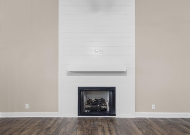 interior details with a large fireplace and hardwood / wood-style floors