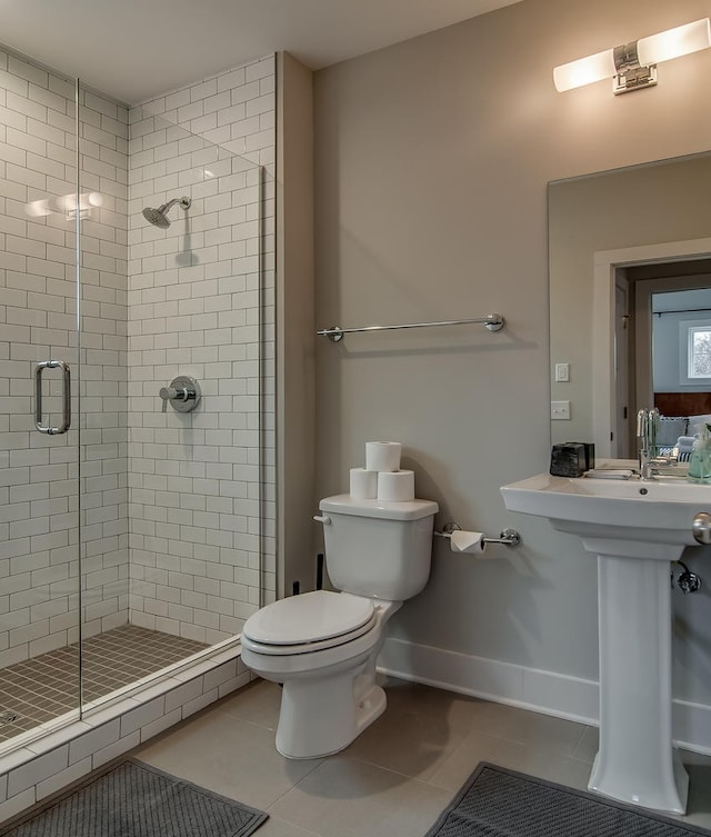 bathroom with tile floors, walk in shower, and toilet