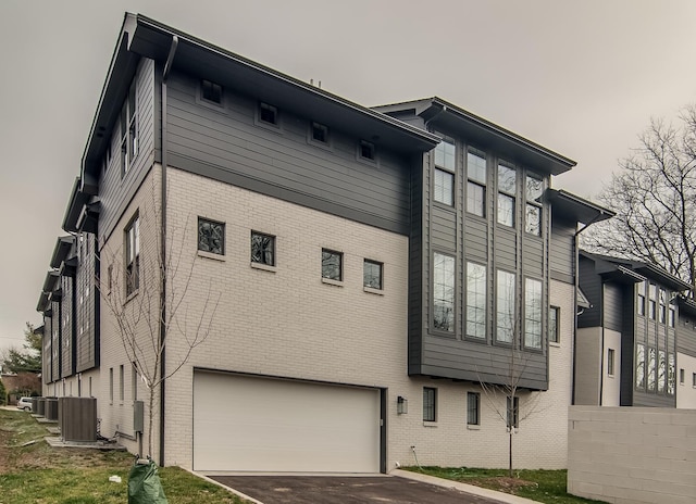 exterior space featuring a garage and central AC unit