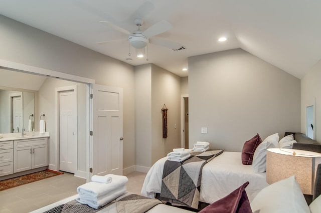 tiled bedroom featuring vaulted ceiling, sink, ensuite bathroom, and ceiling fan