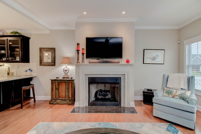 living room featuring wood-type flooring and ornamental molding