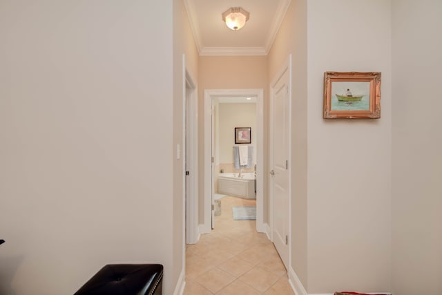 hallway featuring light tile patterned floors and crown molding