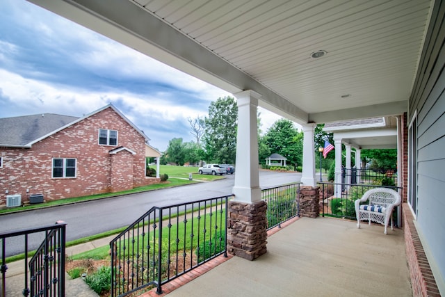 view of patio / terrace with central AC unit and a porch