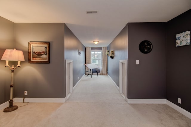 corridor featuring light carpet