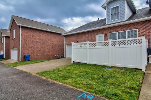 exterior space with a yard and a garage