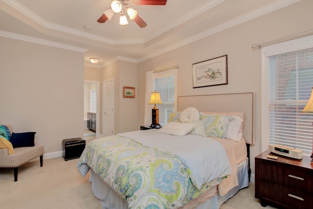 bedroom with a raised ceiling, ceiling fan, light colored carpet, and ornamental molding