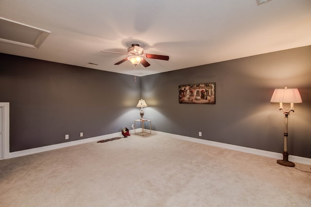 carpeted spare room with ceiling fan