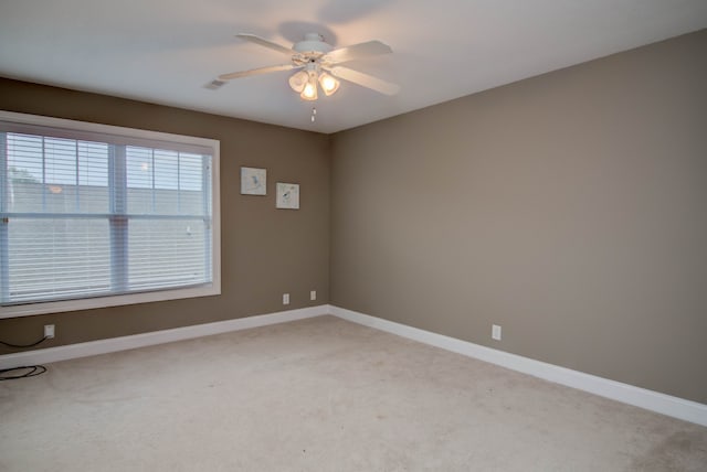 empty room featuring light carpet and ceiling fan