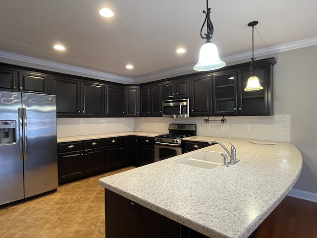 kitchen featuring kitchen peninsula, pendant lighting, sink, and stainless steel appliances