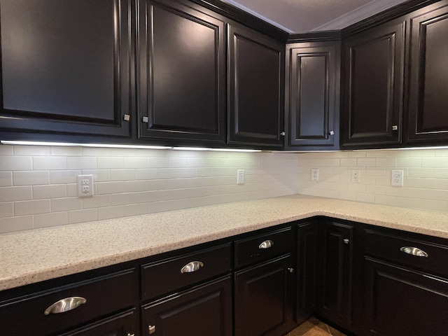 kitchen featuring light stone countertops and decorative backsplash