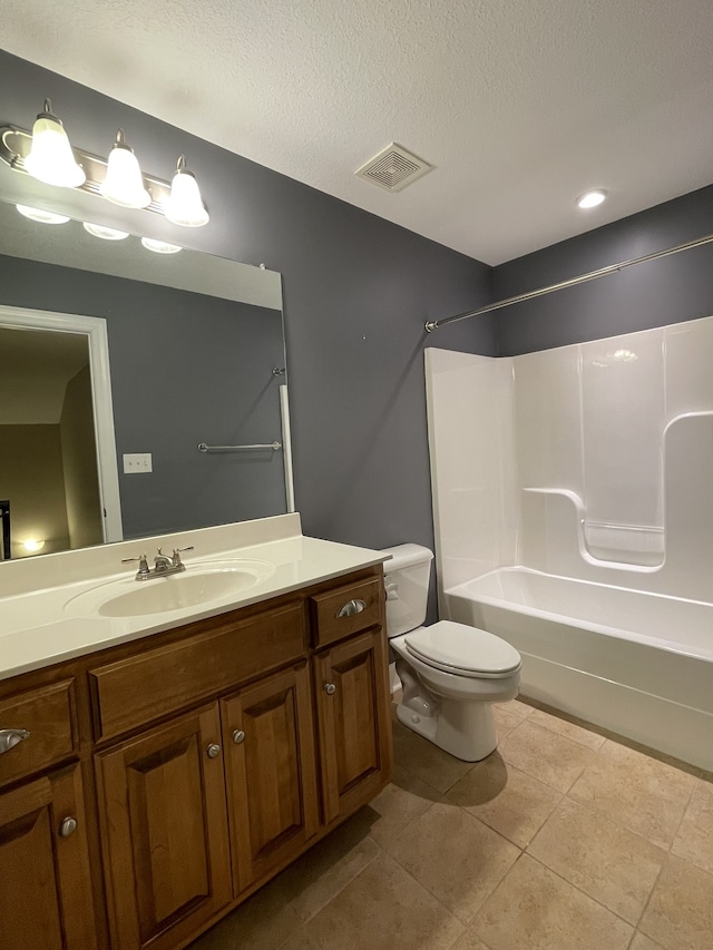 full bathroom with tile patterned flooring, a textured ceiling, toilet, shower / tub combination, and vanity