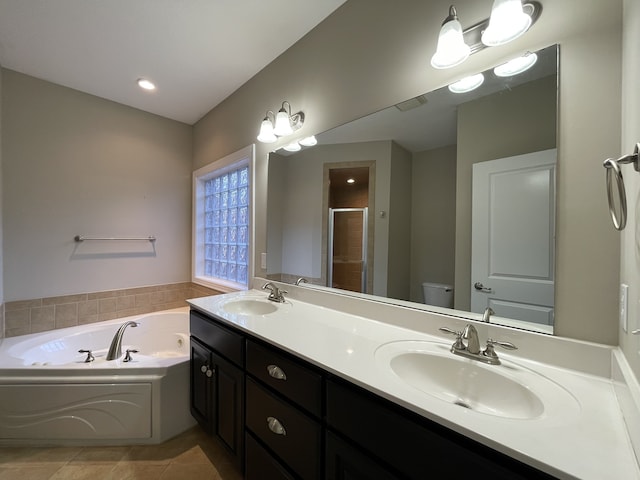 full bathroom with tile patterned floors, vanity, shower with separate bathtub, and toilet