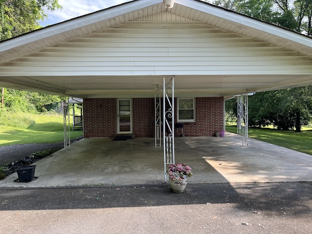 view of car parking featuring a lawn and a carport