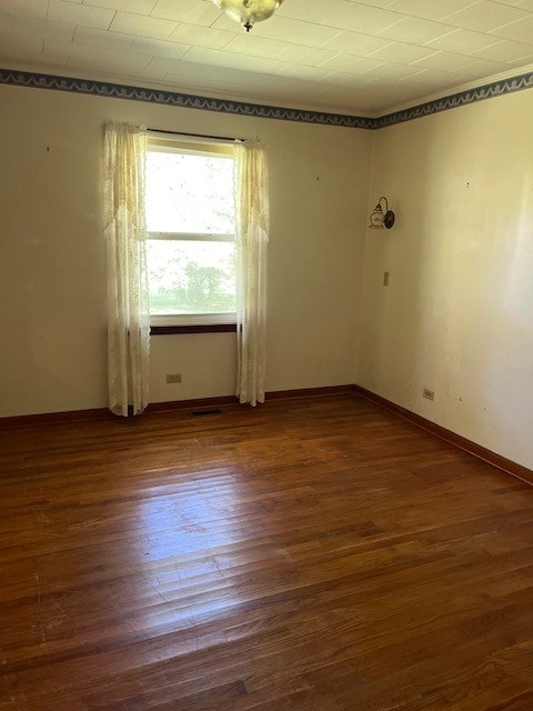 spare room with dark hardwood / wood-style flooring