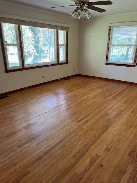 empty room featuring light wood-type flooring, ceiling fan, and plenty of natural light