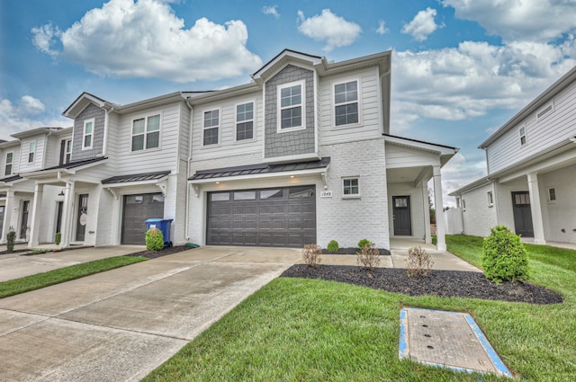 townhome / multi-family property with a front yard and a garage